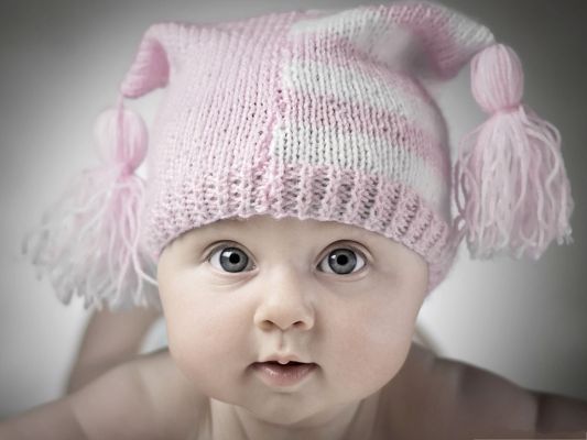 click to free download the wallpaper--Adorable Baby Photography, Baby in Pink Hat, Wide Open Eyes, Curious Facial Expression
