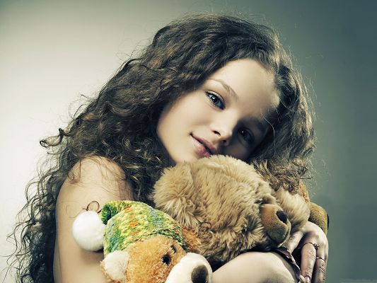 Baby Girl Picture, Beautiful Young Girl with Toys, Satisfied Facial Expression
