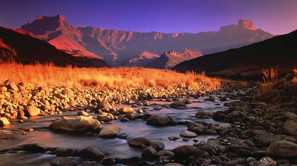 click to free download the wallpaper--Free Download Natural Scenery Picture - High Mountains Next to the Clear River, All Seem Red and Lively