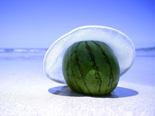 click to free download the wallpaper--Free Fruits Wallpaper, Watermelon On The Beach, Wearing a White Hat