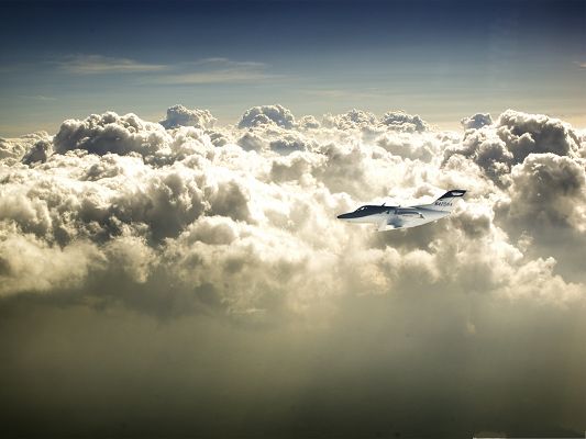 click to free download the wallpaper--Free Plane Wallpaper, Nice Aircraft in Flight, the Twisting Clouds