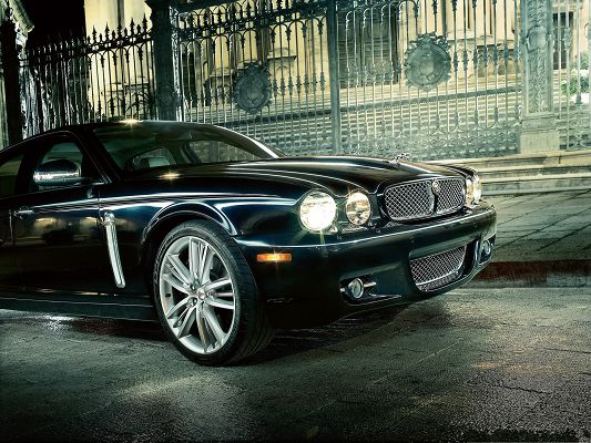 click to free download the wallpaper--Jaguar Car as Wallpaper, Black Super Car Turning a Corner, Lighted Turned on 