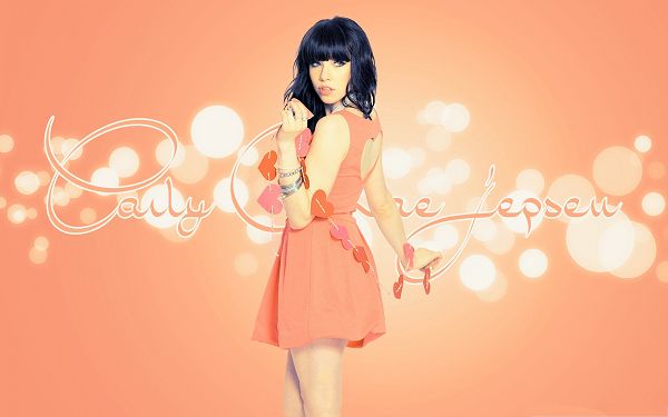 click to free download the wallpaper--Lovely Carly Rae Jepsen, in Orange Heart-Shaped Dress, Light-Colored Background 