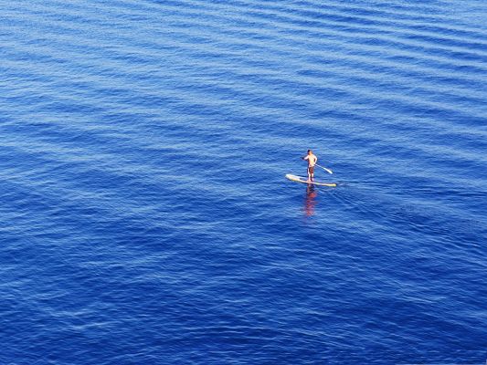 click to free download the wallpaper--Man Wallpaper, Man Going Boating in the Blue Sea, Nice Journey