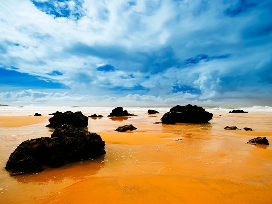 click to free download the wallpaper--Nature Landscape Pic, Big Rocks on the Beach, Yellow River, the Blue Sky