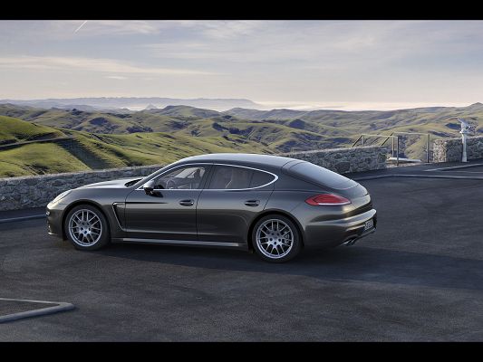 click to free download the wallpaper--Pics of Top Cars, Porsche Panamera in Face of Green and Numerous Mountains, Fit Each Other Well