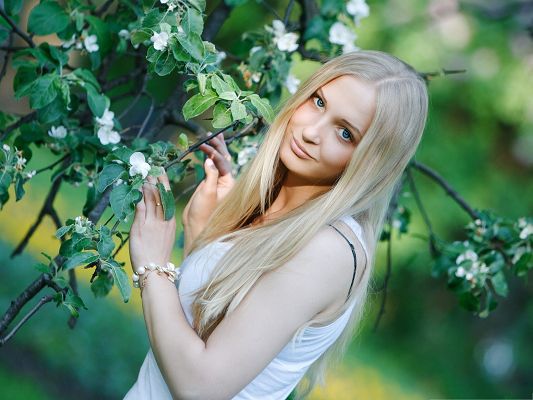 click to free download the wallpaper--Pretty Girl Pictures, Light Blonde Woman Smiling Among Blooming Flowers