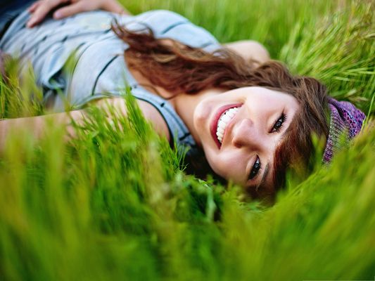 click to free download the wallpaper--Smiling Girl Photos, Lying on Green Grass, Wide Open Smile