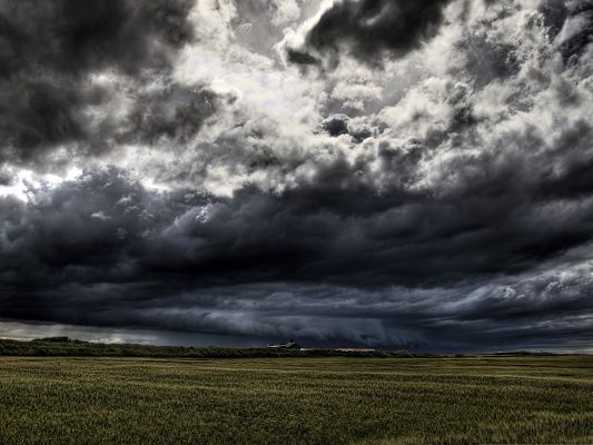 click to free download the wallpaper--Upcoming Storm Landscape, Thick Clouds Over the Green Grass, Heavy Storm