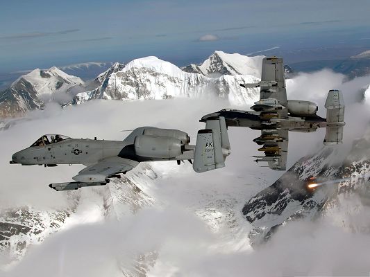 click to free download the wallpaper--War Airplanes Wallpaper - Super Planes Among Snow-Capped Mountains